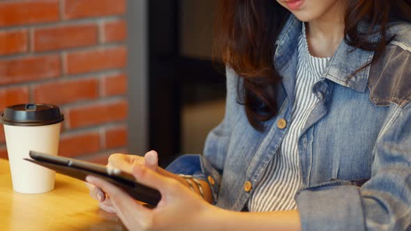 Young caucasian woman using digital tablet for her business.