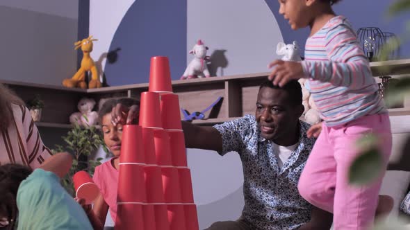 Mixed Race Girls Playing on Bed with Parents alt