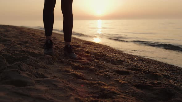 Sporty Girl Putting Down Mat at Sunrise alt