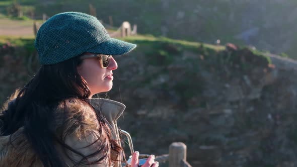 woman drinking yerba mate, typical Argentine drink, on the beach, while watching the sunset chile alt