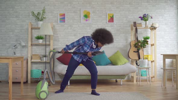 Expressive Positive African American Young Woman Housewife Busy with Homework Vacuuming and Singing alt