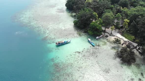 Aerial view of a beautiful island in the ocean with a boat