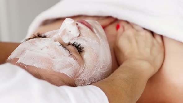 Beautician cosmetologist makes a massage of the cervical collar zone of the décolleté alt