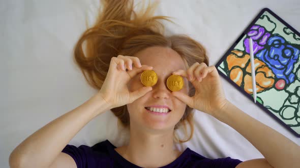 Woman Digital Artist Contemporary Painter Holds NFT Coins in Her Hands alt