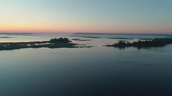 Aerial Drone Footage. Fly Over River with Islands at Sunrise