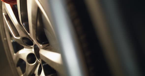 Putting the Wheel on a Machine Tool for Balancing Tire in Tire Service alt