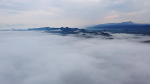 Landscape in the morning time during sunrise with fog above the mountain, alt