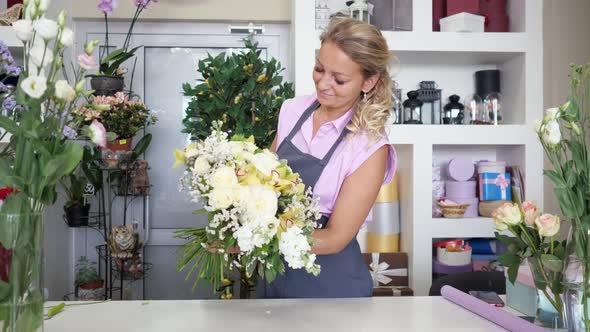 Woman Professional Florist Makes Huge Flower Bouquet in Floristic Studio alt