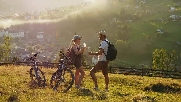 Tourists Riding Bicycles in the Mountains, Resting, Drinking Water