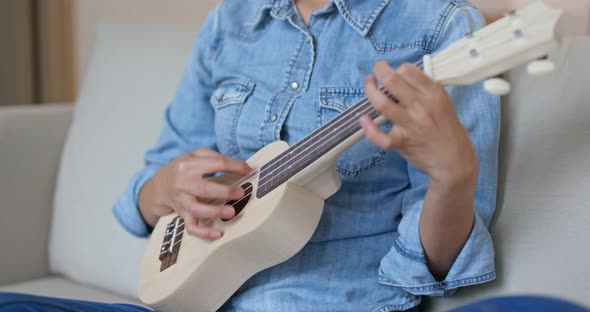 Woman Play with Ukulele at Home alt