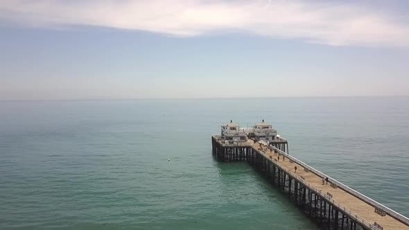 Famous pier from about 1905 on the beach in summerButtery soft aerial view flight fly backwards dro alt