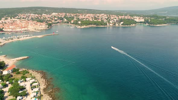 Aerial view of boat arriving at Krk bay during the summer, Croatia. alt