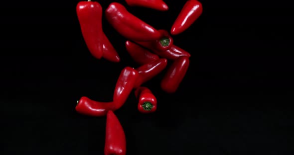 Red Sweet Pepper, capsicum annuum, Vegetables falling against Black Background, Slow motion 4K alt