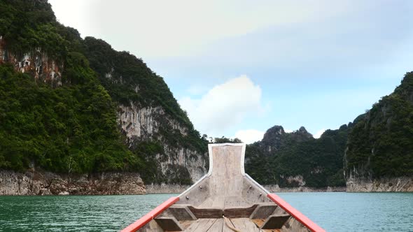 Tour on Lake on Wood Longtail Boat Near Limestone Cliffs and Tropical Forest alt