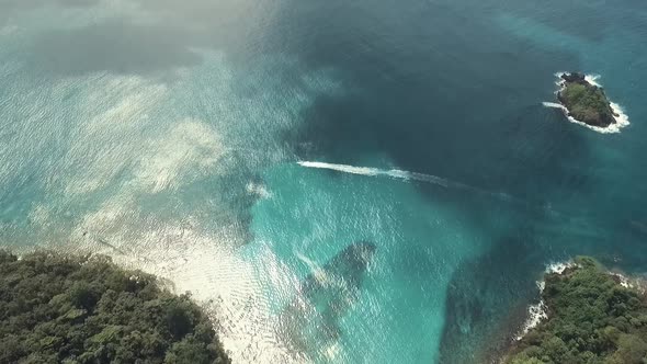 Drone footage of a ferry boat passing by at one of Panama's caribbean island alt