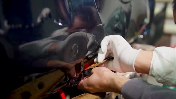 Two Men in the Service Station Put Vinyl on the Machine alt