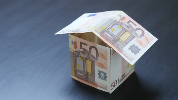 Investing in real estate metaphor with Euero paper 50 banknotes 4K 3840X2160 30fps UHD video - Abstr alt