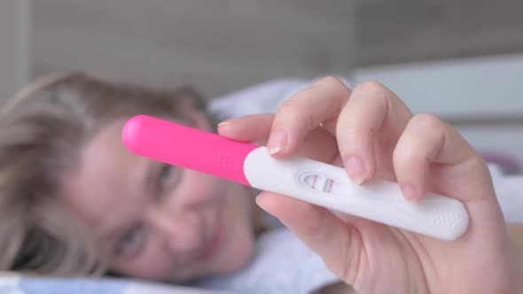 Woman with Pregnancy Test alt
