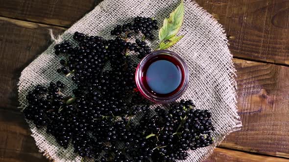 Elderberry Juice In A Glass Jar. Black Elderberry On A Wooden Background. Herbal Medicine.Homeopathy