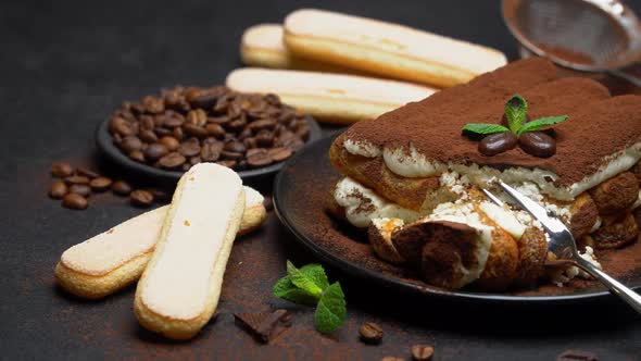Portion of Classic Tiramisu Dessert and Savoiardi Cookies on Concrete Background alt