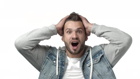 Slowmotion Portrait Attractive Guy Feeling Lucky and Astonished Grab Head Widen Eyes Amazed and alt