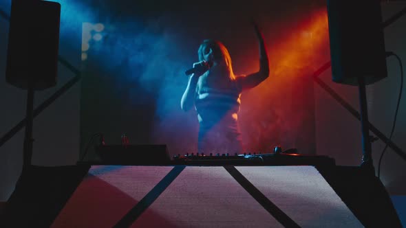 Dancing Woman Playing Decks in Club alt