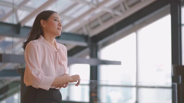 Office break, Young asian business woman walked out after the meeting was over alt