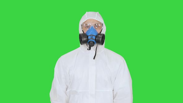 Epidemiologist Showing Stop Sign and Showing Cross with His Hands on a Green Screen, Chroma Key. alt