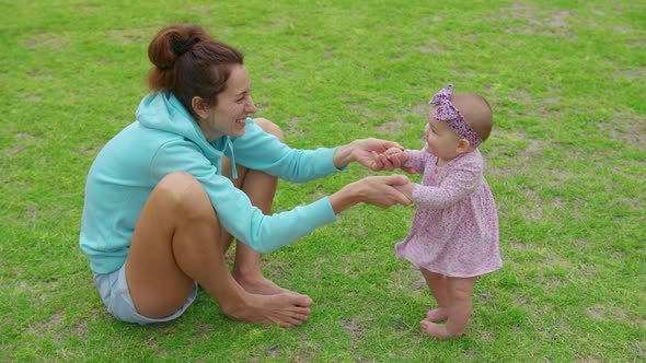 Happy Little Baby Girl Playing Together with Her Mother Outdoor in the Park Adorable Baby Lifestyle alt