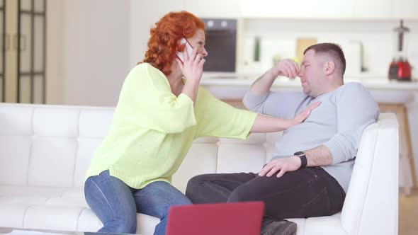 Stressed Worried Caucasian Woman Calling Ambulance As Man Having Symptoms of Heart Attack alt