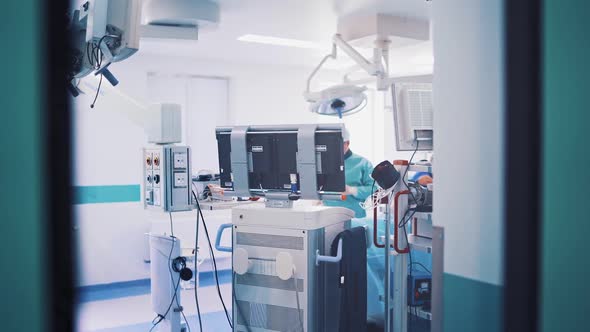 Operating room with modern equipment and surgeons in medical uniform alt