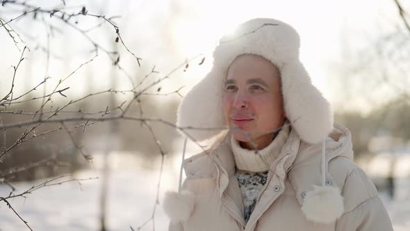 Walk in Nature in January Cold Day Handsome Smiling Man is Exploring Winter Forest in Sunny Weather alt