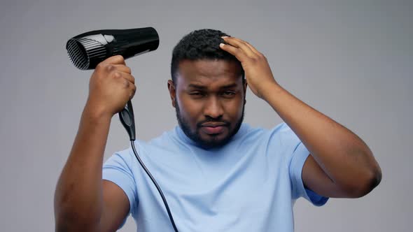 African American Man with Fan or Hair Dryer, Stock Footage VideoHive