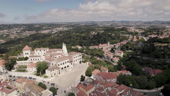 Set of buildings of Sintra National Palace with two conical chimneys standing out. Aerial view alt