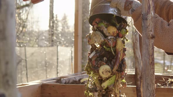 SLOW MOTION CLOSEUP, stunning shot of food waste bucket being emptied alt