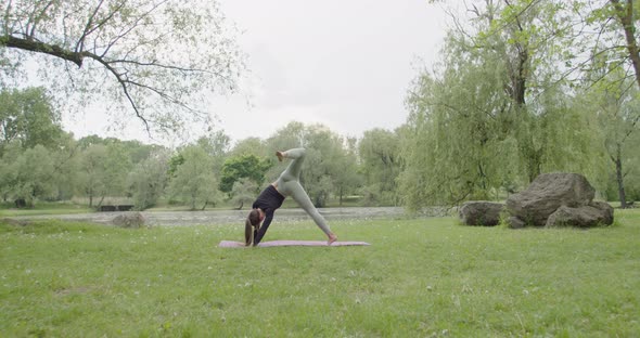 Sporty Young Woman Doing Yoga Wide Angle of Fit Woman Doing the Knee Lift Pose Practicing in a alt