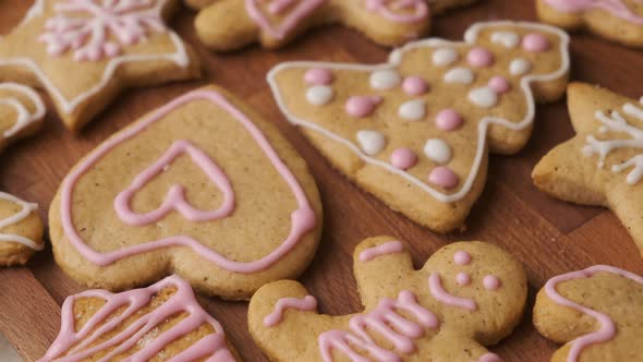 Decorating Gingerbread Cookies for Christmas on the Wooden Desk alt