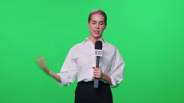 Breaking News Female Reporter in Suit Looks Into the Camera and Speaks Into a Microphone on a Green alt