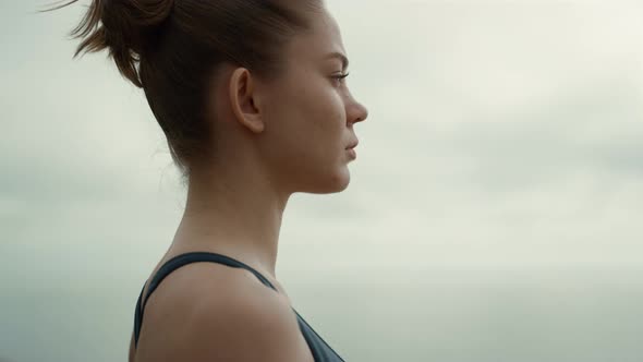 Sporty Girl Turning Face to Camera Practicing Yoga Exercise on Beach Close Up alt