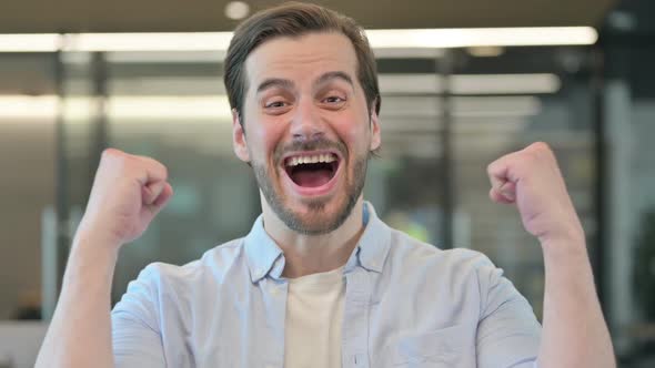 Portrait of Successful Mature Adult Man Celebrating Win alt