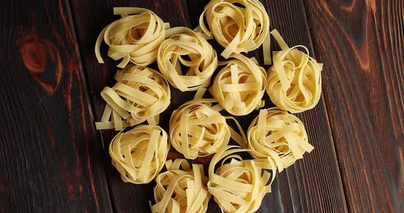 Bunches of Raw Pasta on Table alt