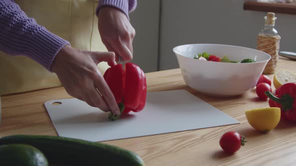 Woman Is Cutting Red Sweet Pepper