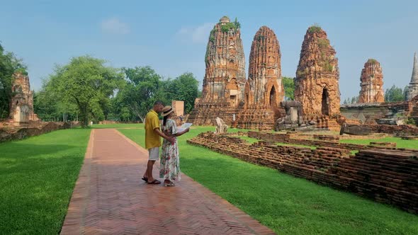 Ayutthaya Thailand at Wat Mahathat Couple Men and Women with a Hat and Tourist Map Visiting alt