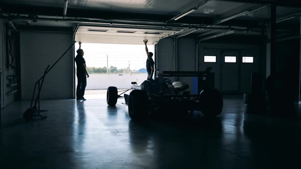 Specialists are Preparing a Racing Cart for the Race alt