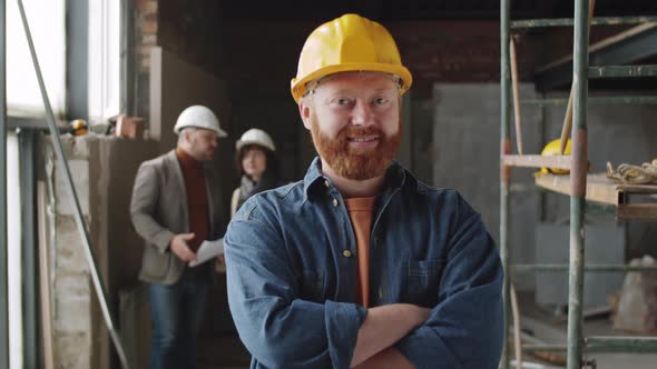 Portrait of Smiling Male Architect in Helmet at Construction Site alt