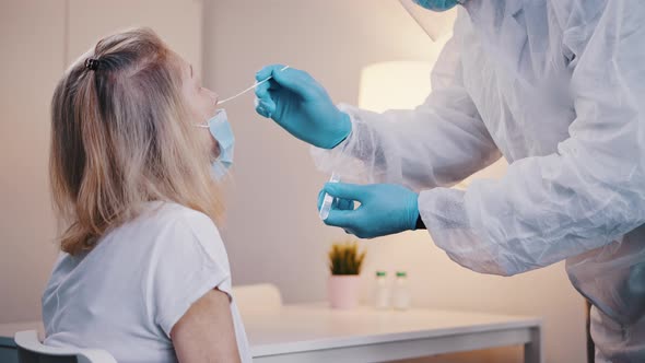 Doctor Performing Nasal Swab Covid Test on an Elderly Woman alt