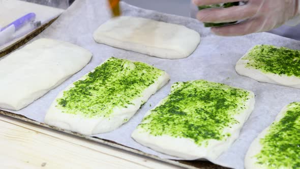 Chef Makes a Pizza and Spreads It with Pesto Sauce alt