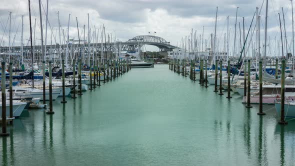 Time Lapse Auckland Harbour Bridge Reflecting on Westhaven Marina in Auckland alt