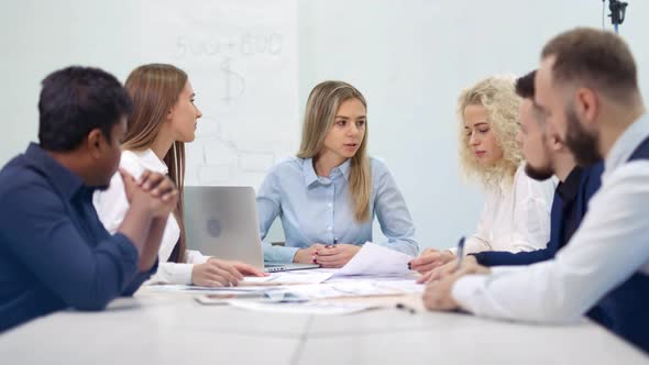 Group of Smiling Multiethnic Business People Having Team Meeting and Brainstorming at Modern Office alt