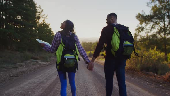 Young couple on a trek in countryside alt